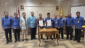 Rektor UNCEN dan Rektor UHO Menunjukkan Dokumen MoU